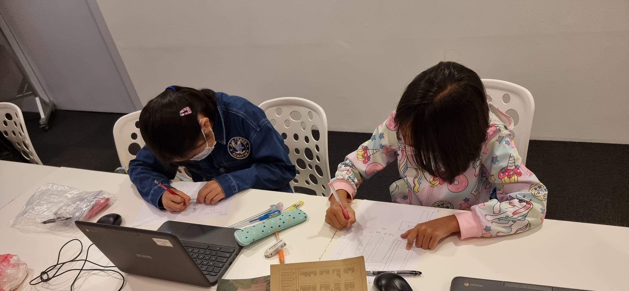 Students planning a game design on paper before building it