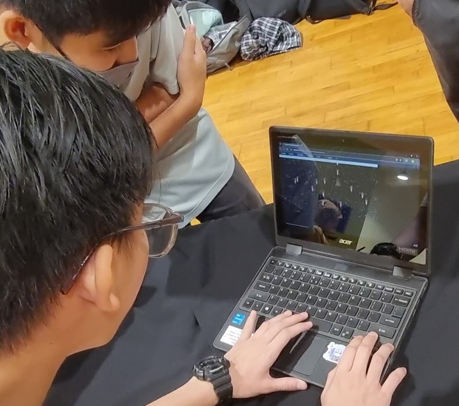 Two students playtesting a classmate’s game at a DotCode Campus showcase