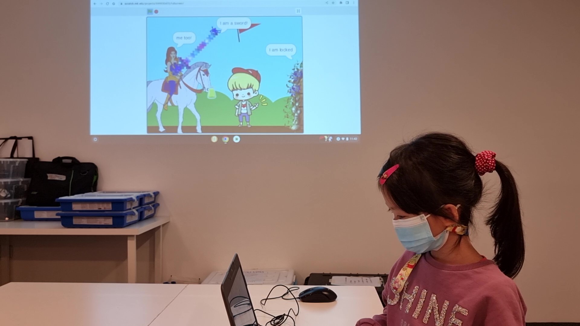 An instructor walking a class through a Scratch project on the projector