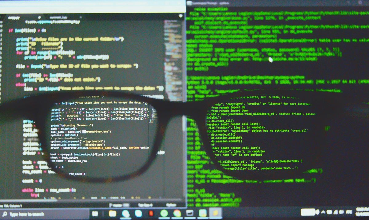 Python code on a screen, brought into focus through a pair of glasses